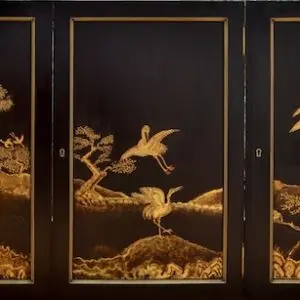 A black and gold mural design illustrating birds and trees, part of a larger artistic project celebrating nature.