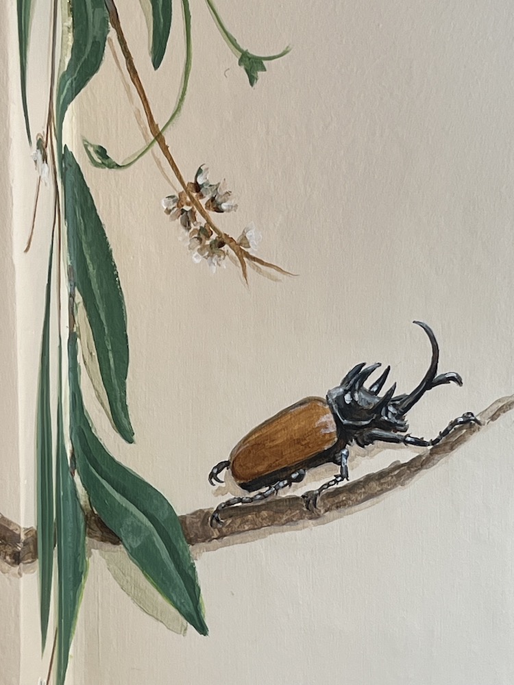 A detailof a mural with a beatle