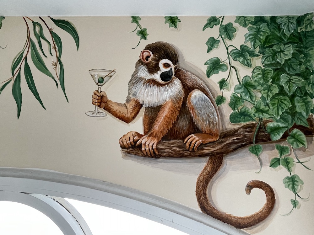 Mural detail with a monkey holding a cocktail